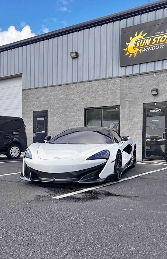 Tinted white sports car outside