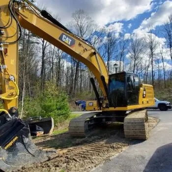 Excavator beside tinted service van