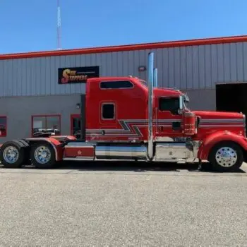 Red semi truck outside tint shop
