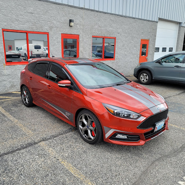 Red hatchback with tinted windows